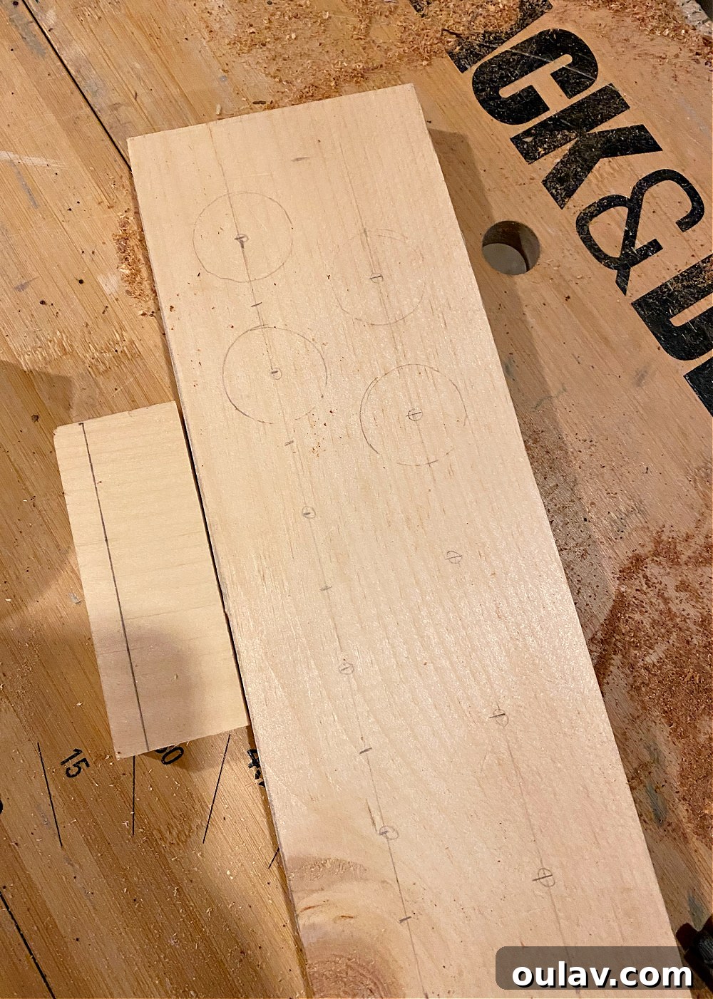 Using a ruler and pencil to accurately mark drill points on the wooden board.