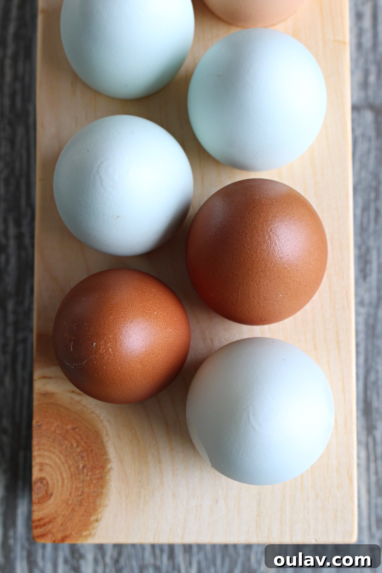 wood egg tray - A beautifully crafted wood egg tray holding fresh eggs, ideal for kitchen organization and display.