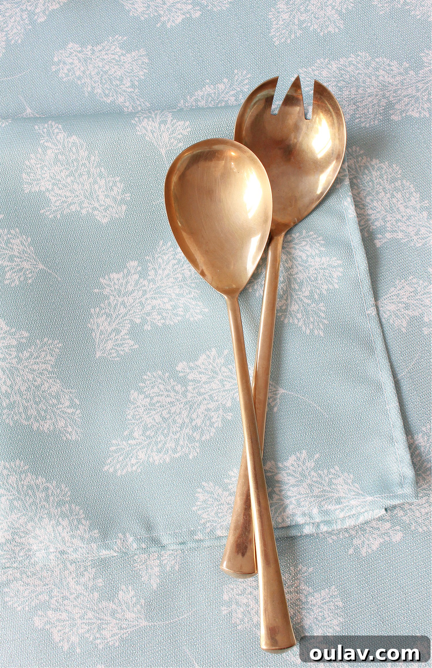 Loom and Table's Summer Dining Oasis 19 Close up of vintage brass flatware on a custom Loom & Table tablecloth