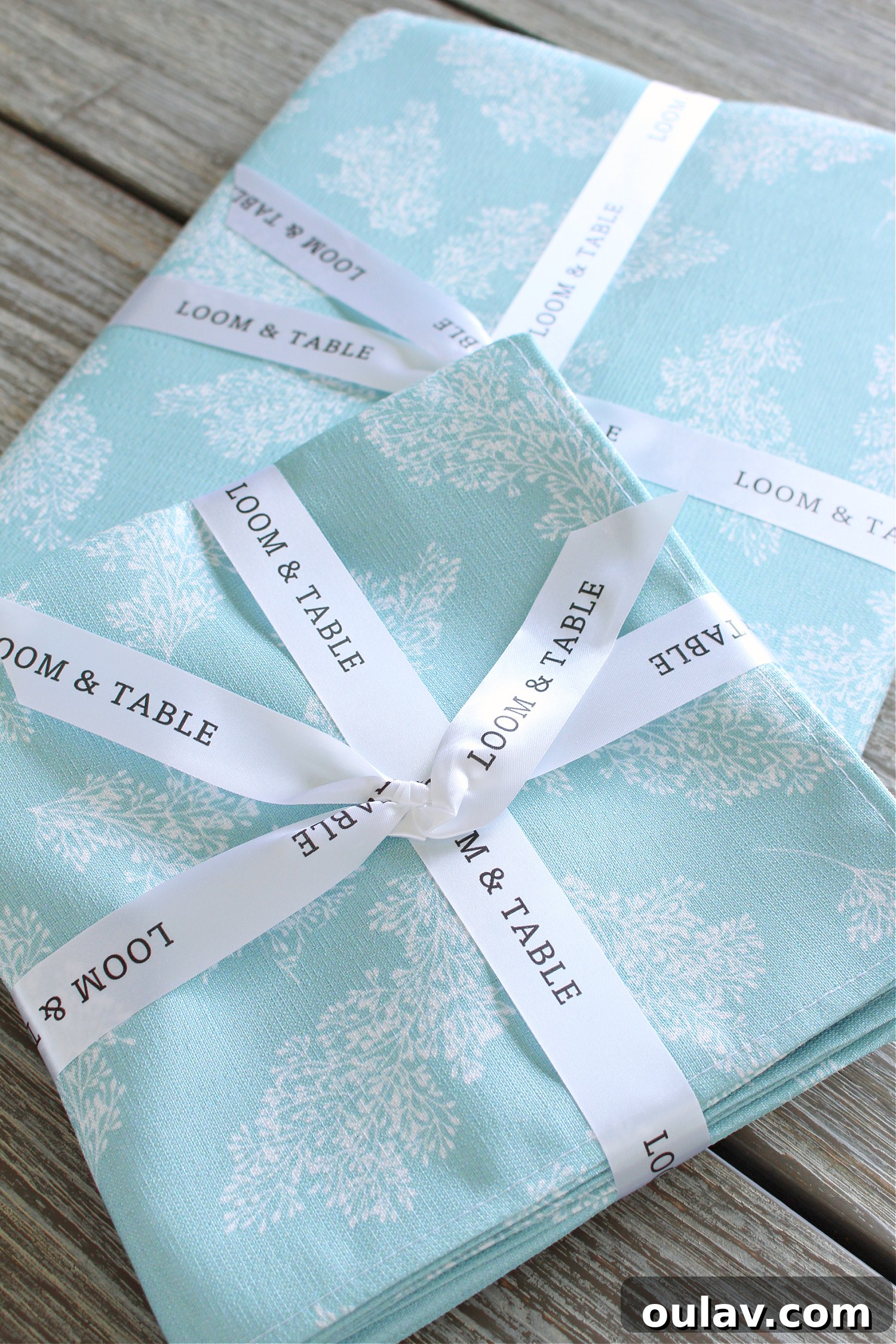 Loom and Table's Summer Dining Oasis 8 Aqua custom table cloth with white sprig design from Loom & Table