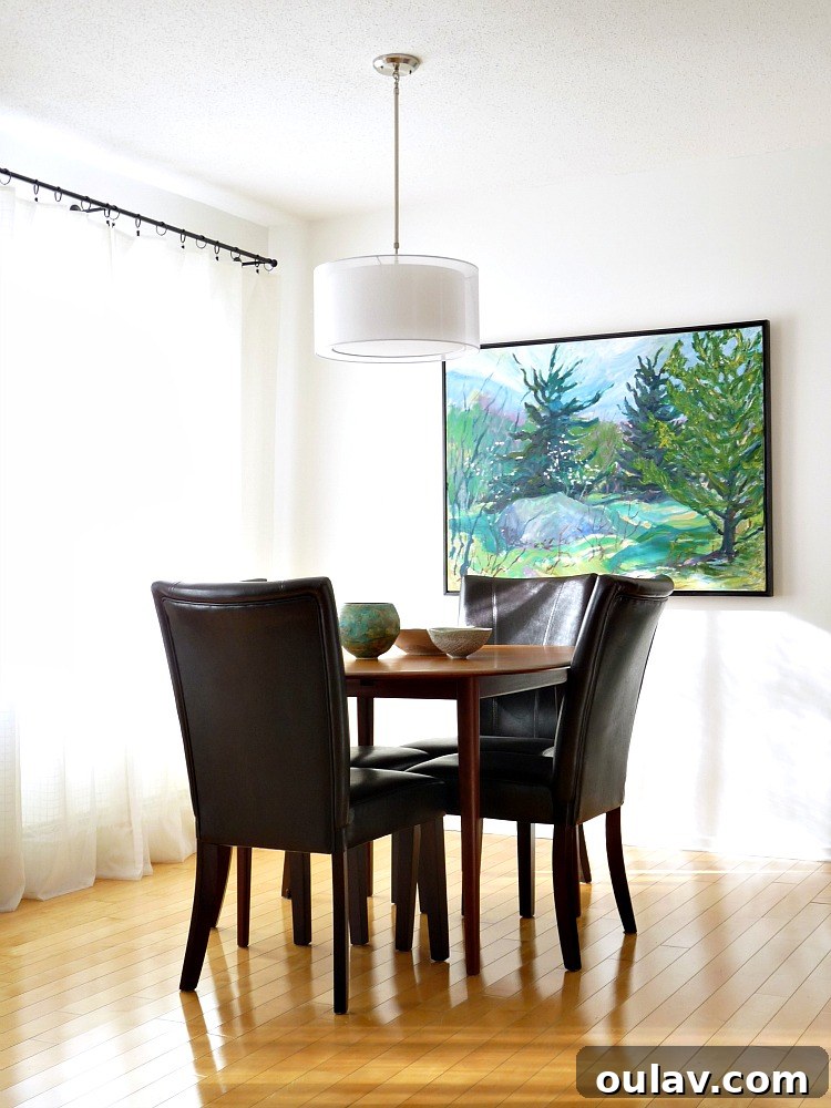 Grandpa's Brushstrokes: A Family Art Journey 13 Minimalist Dining Room with Large Bert Weir Landscape Painting 'Joy's Rock'