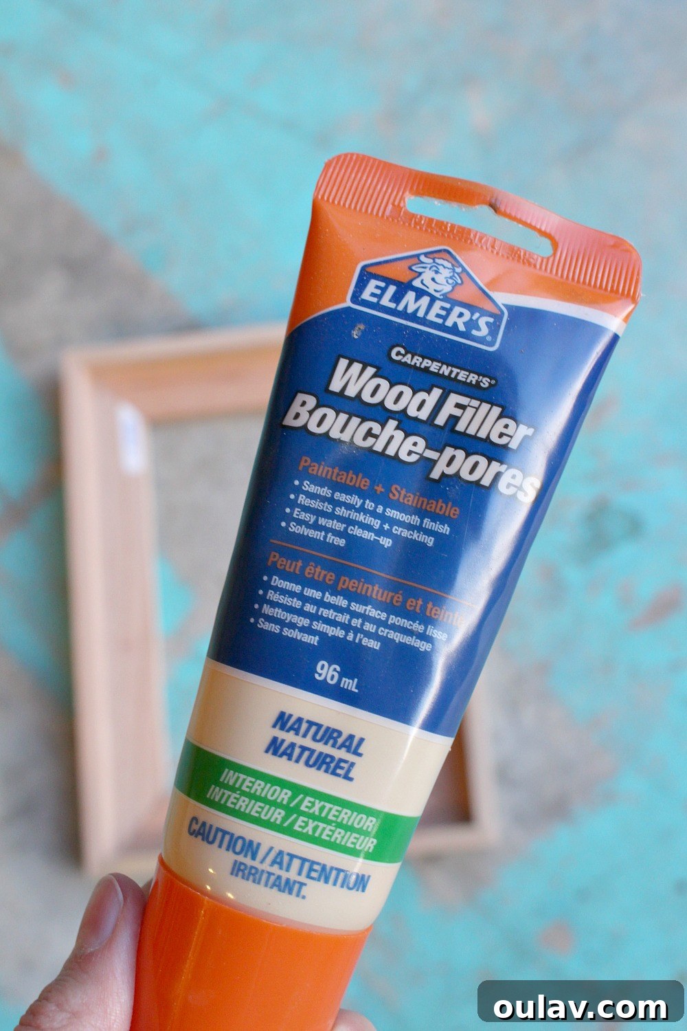 Simple Floating Frame Craft 18 Applying wood filler to hide nail holes in the DIY frame before staining