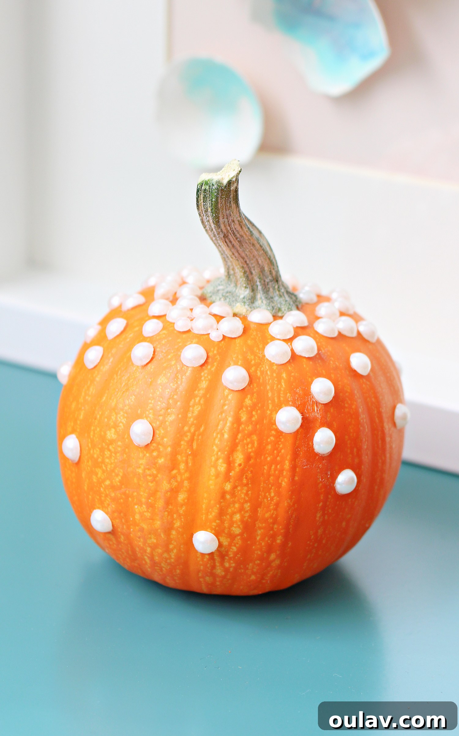 Various pearl-embellished pumpkins showcasing different pearl sizes and arrangements