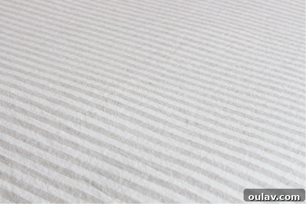 April Notes: Your Sanctuary for Winter Comfort 7 Beige and White Striped Linen Bedding in a Light Room