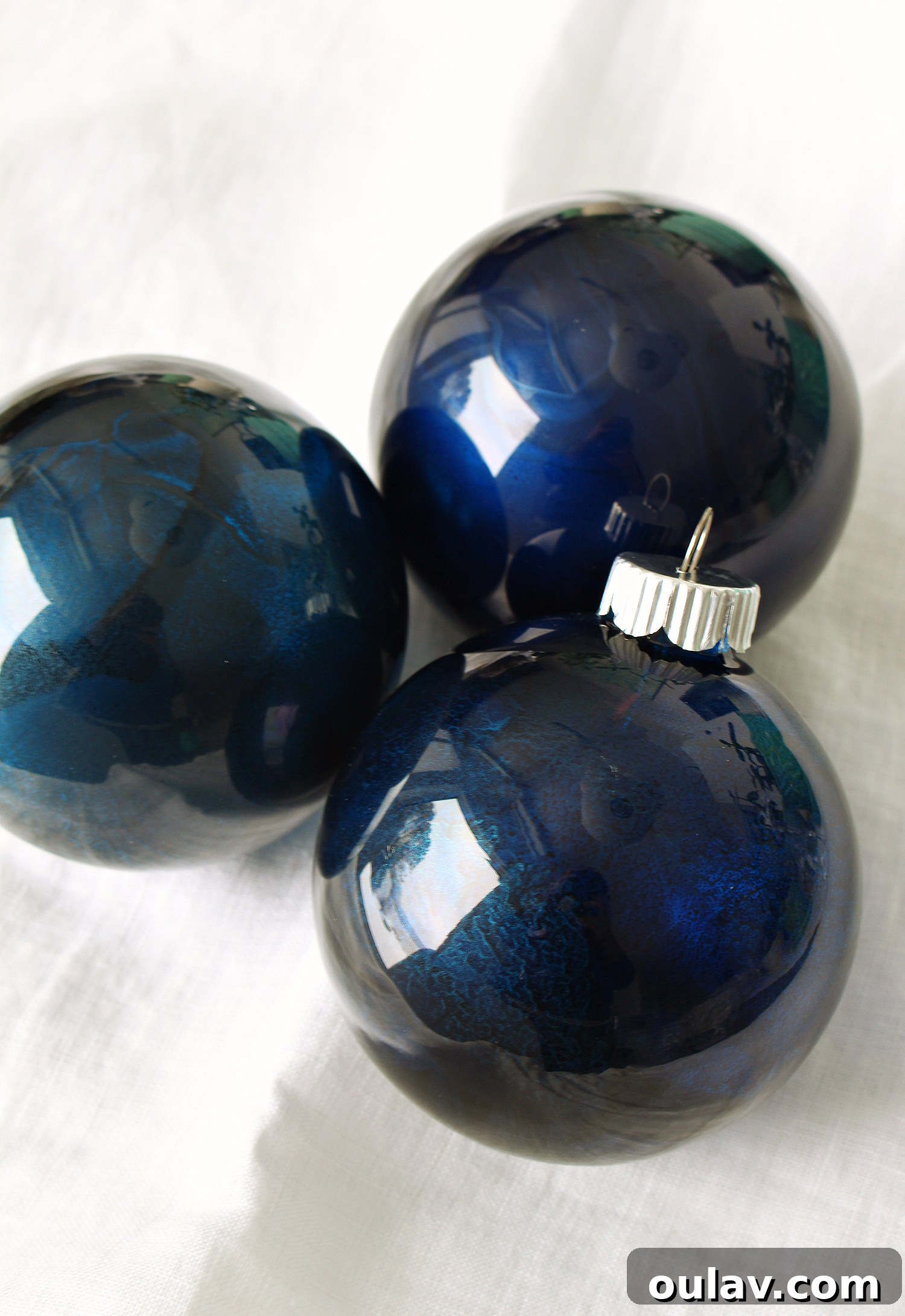 Cricut Starry Night Ornament Project 6 Indigo Alcohol Ink Ornaments drying on a stand