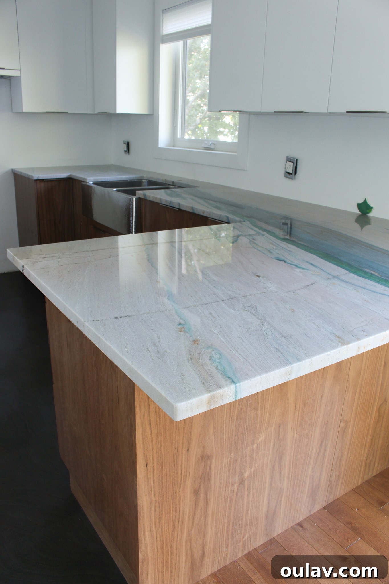 Magnificent Portomare Quartzite counters showcasing intricate veining and vibrant teal hues in the finished kitchen