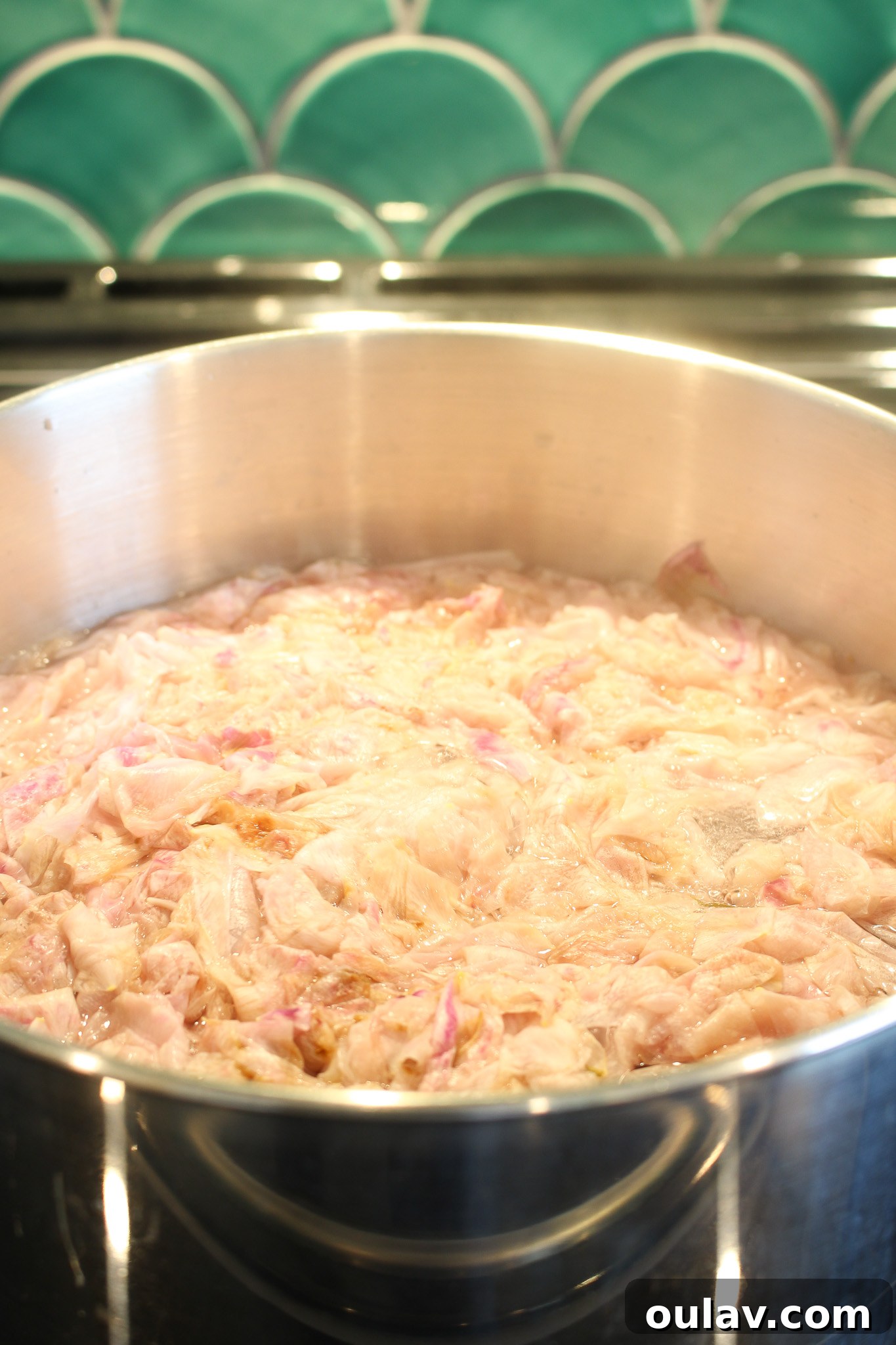 Close-up of rose petals after simmering, having lost their vibrant color, indicating the infusion is complete.