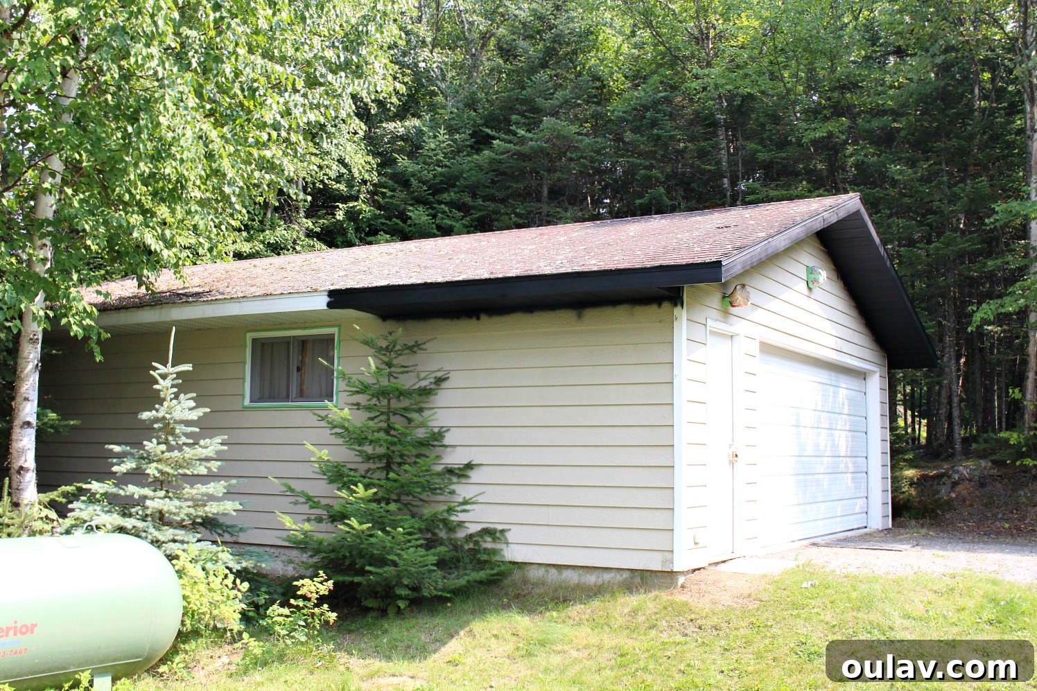 A section of the garage with newly painted black soffit and fascia, showing the completed look.