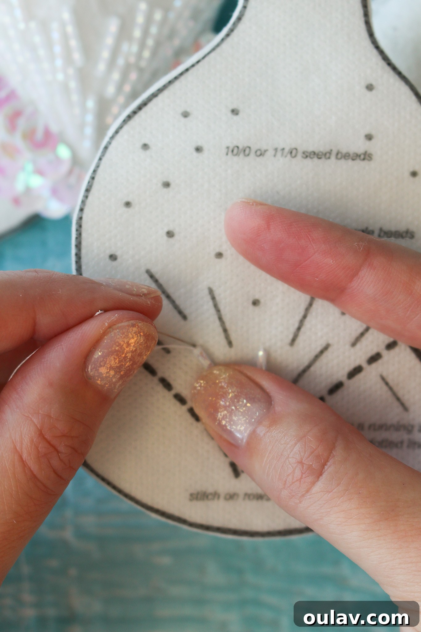 How to Stitch Beads onto Felt - Needle going down