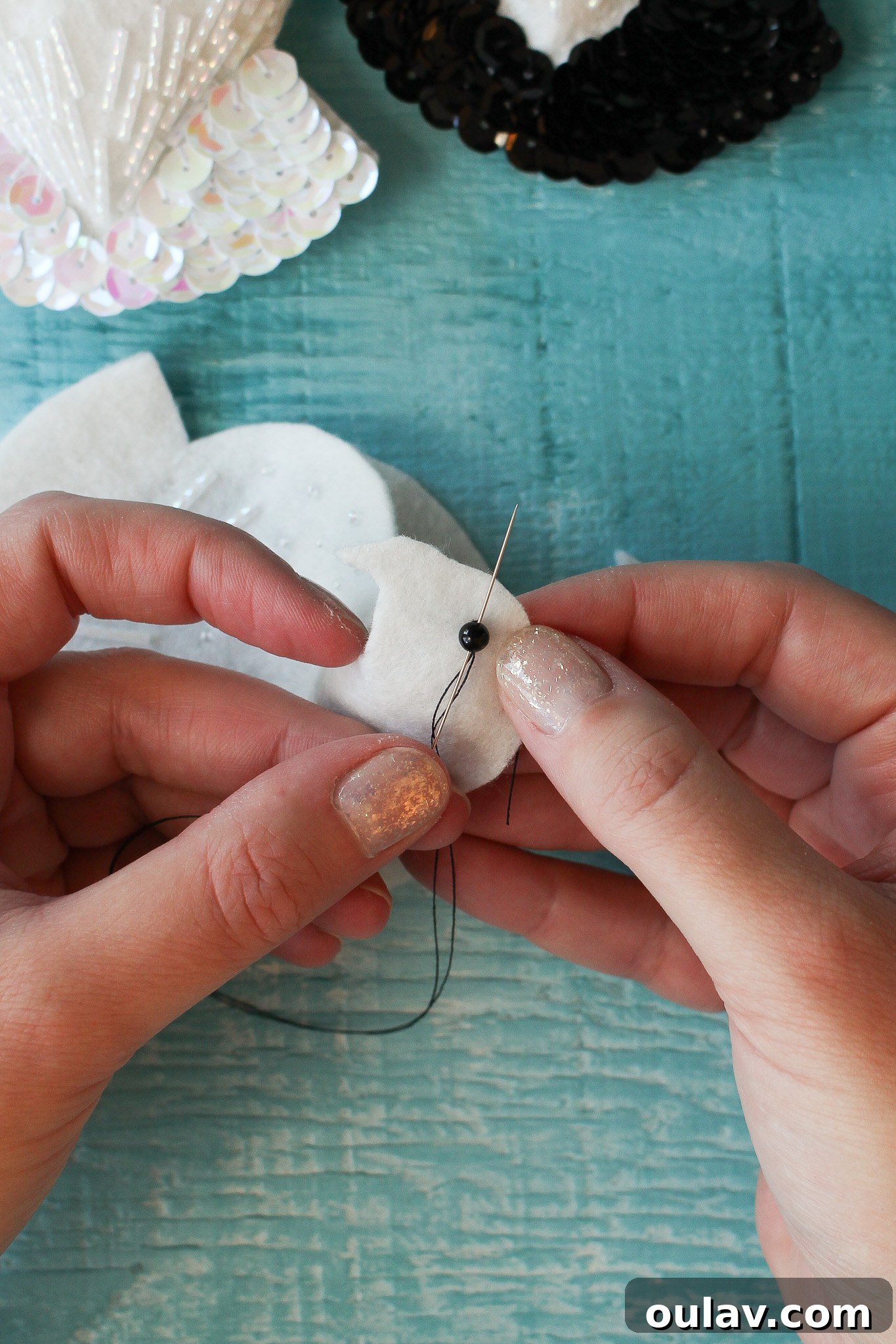 DIY Felt Animal Ornament Tutorial - Attaching eye bead