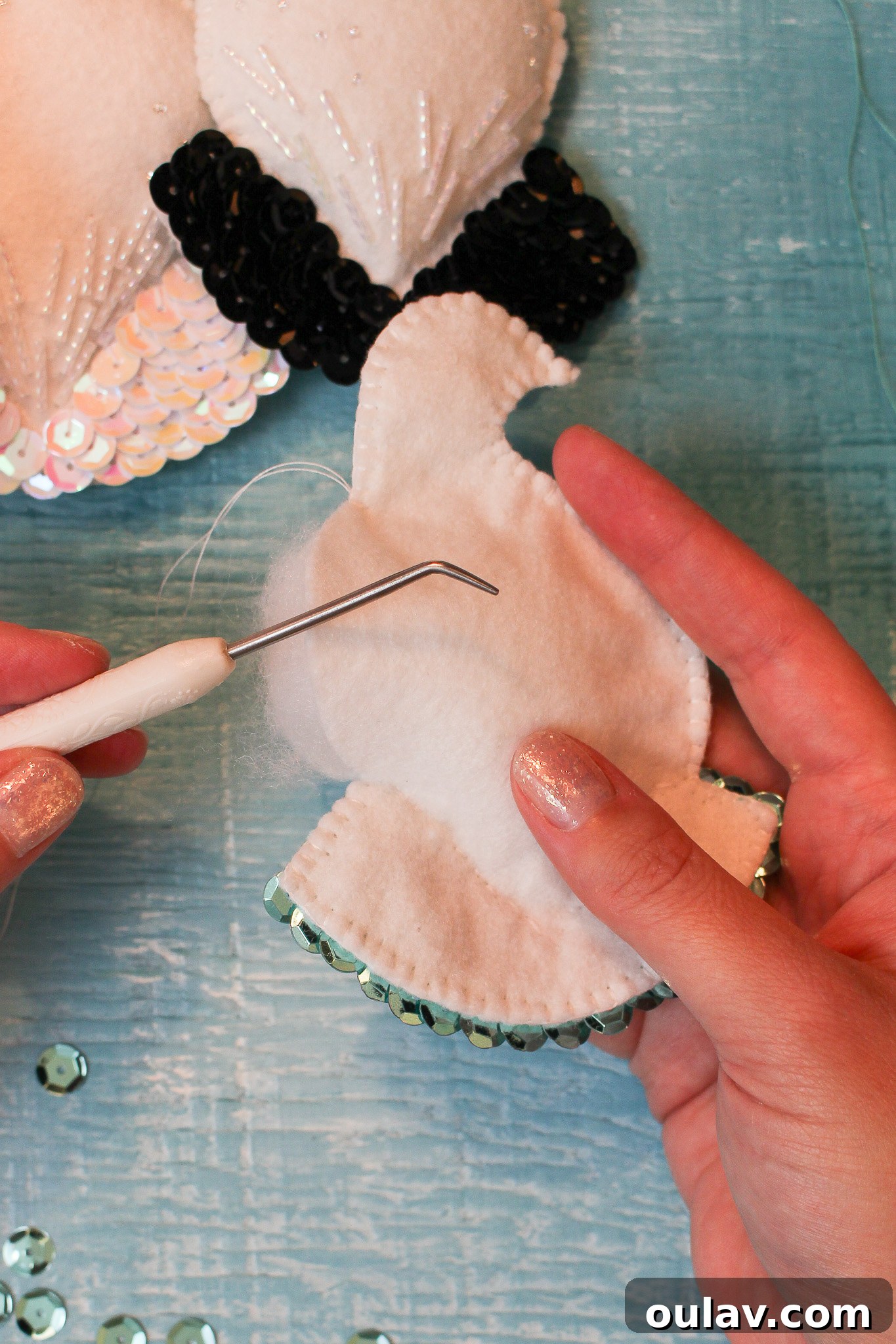 How to Get Batting into Felt Ornament Shapes - Stuffing tool in action