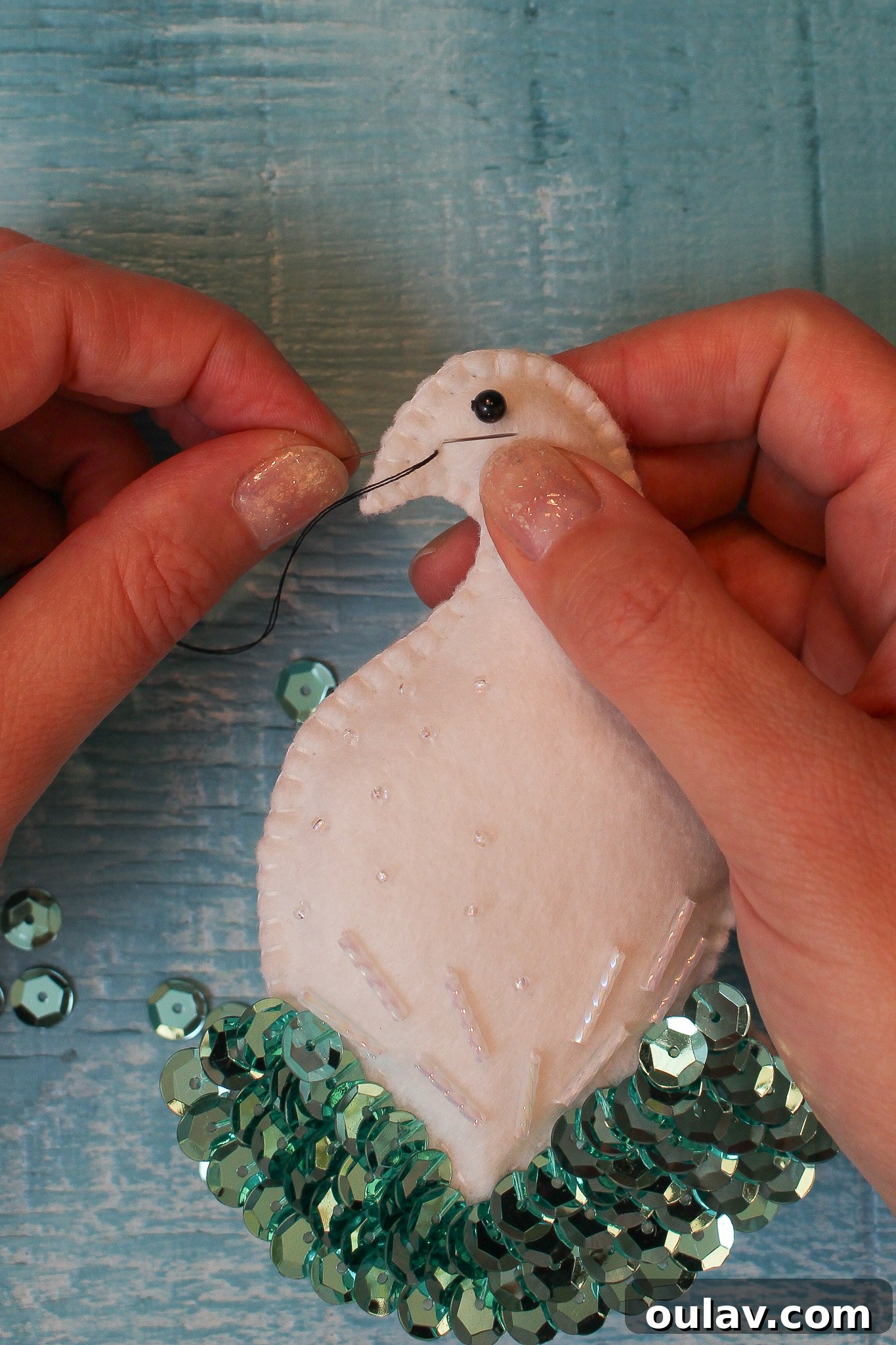Stitching the felt bird's beak