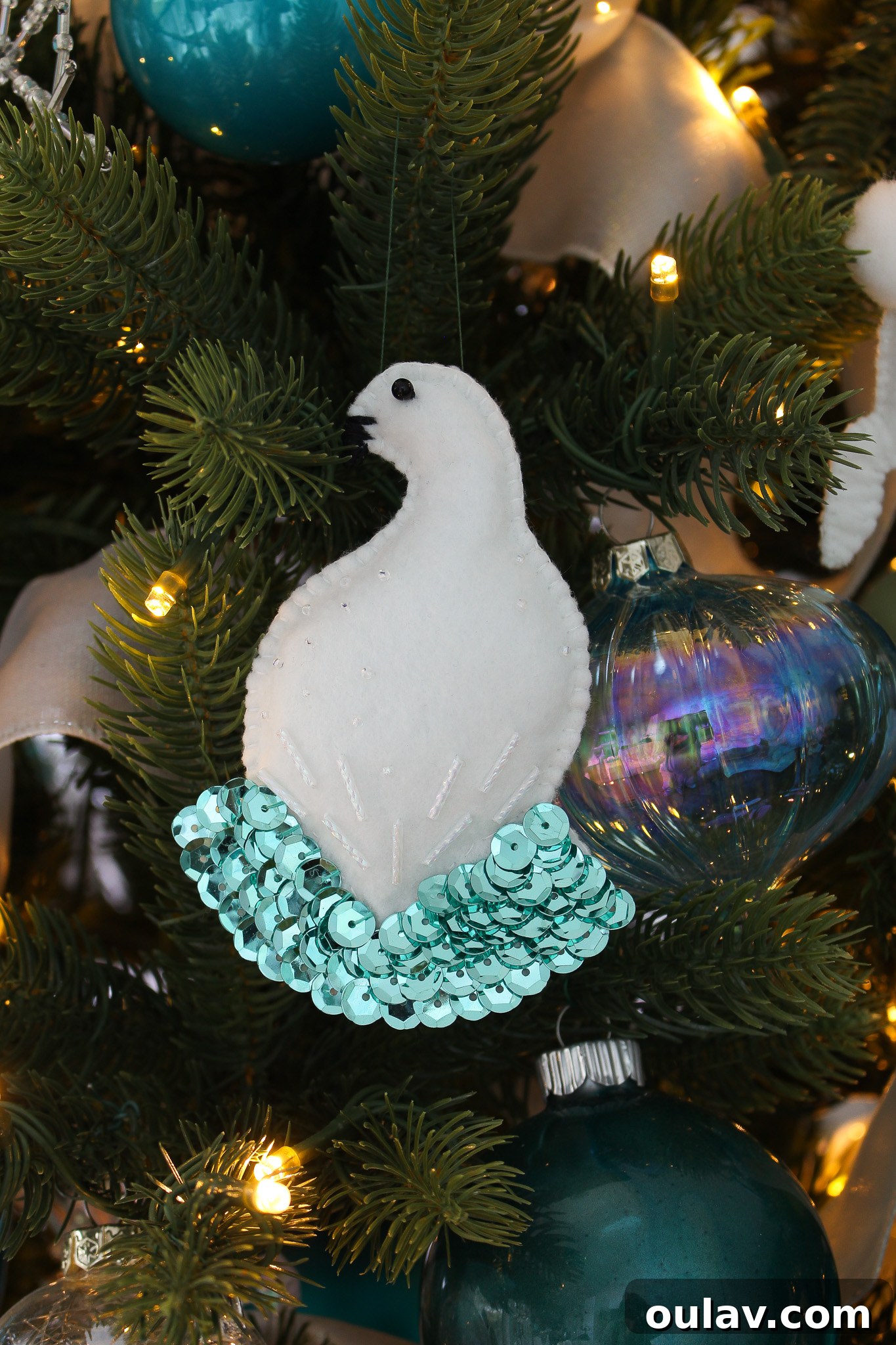 Group of handmade felt bird ornaments on a tree