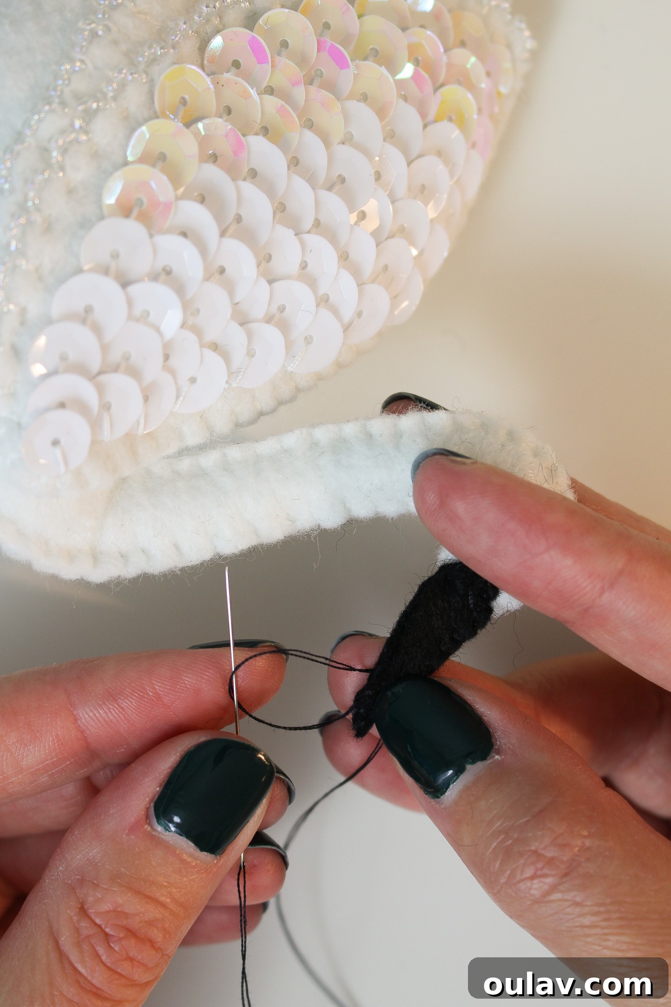 Stitch Your Own Felt Swan Ornament 49 Attaching the black felt beak to the swan's head