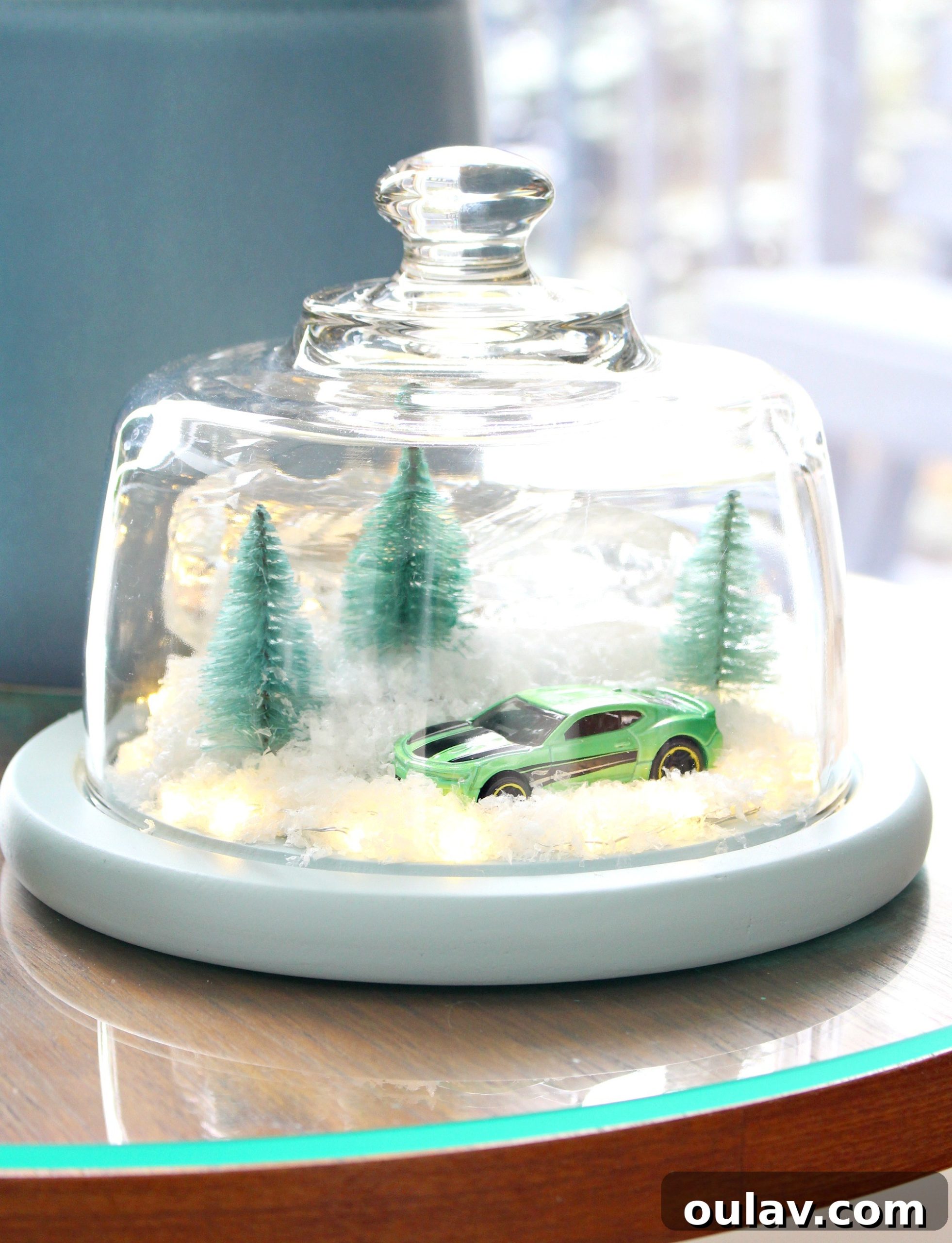 Gearhead's Festive Display Dome 15 A unique holiday decoration: a DIY winter diorama with a classic Camaro model under a glass dome, bringing personality to festive decor.