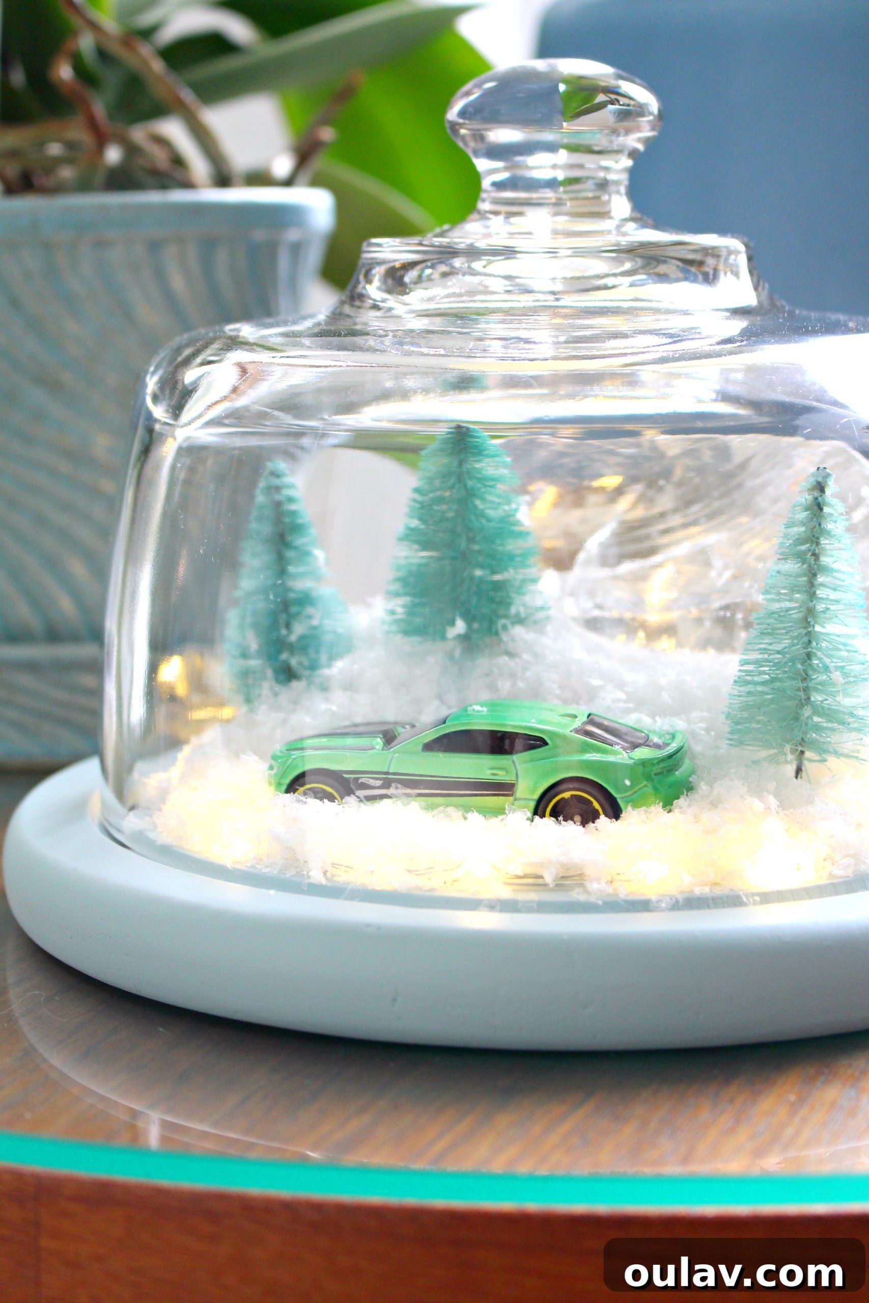 Gearhead's Festive Display Dome 3 Close-up of a DIY winter cloche showcasing a green toy Camaro in a snowy scene, perfect for unique holiday decor.