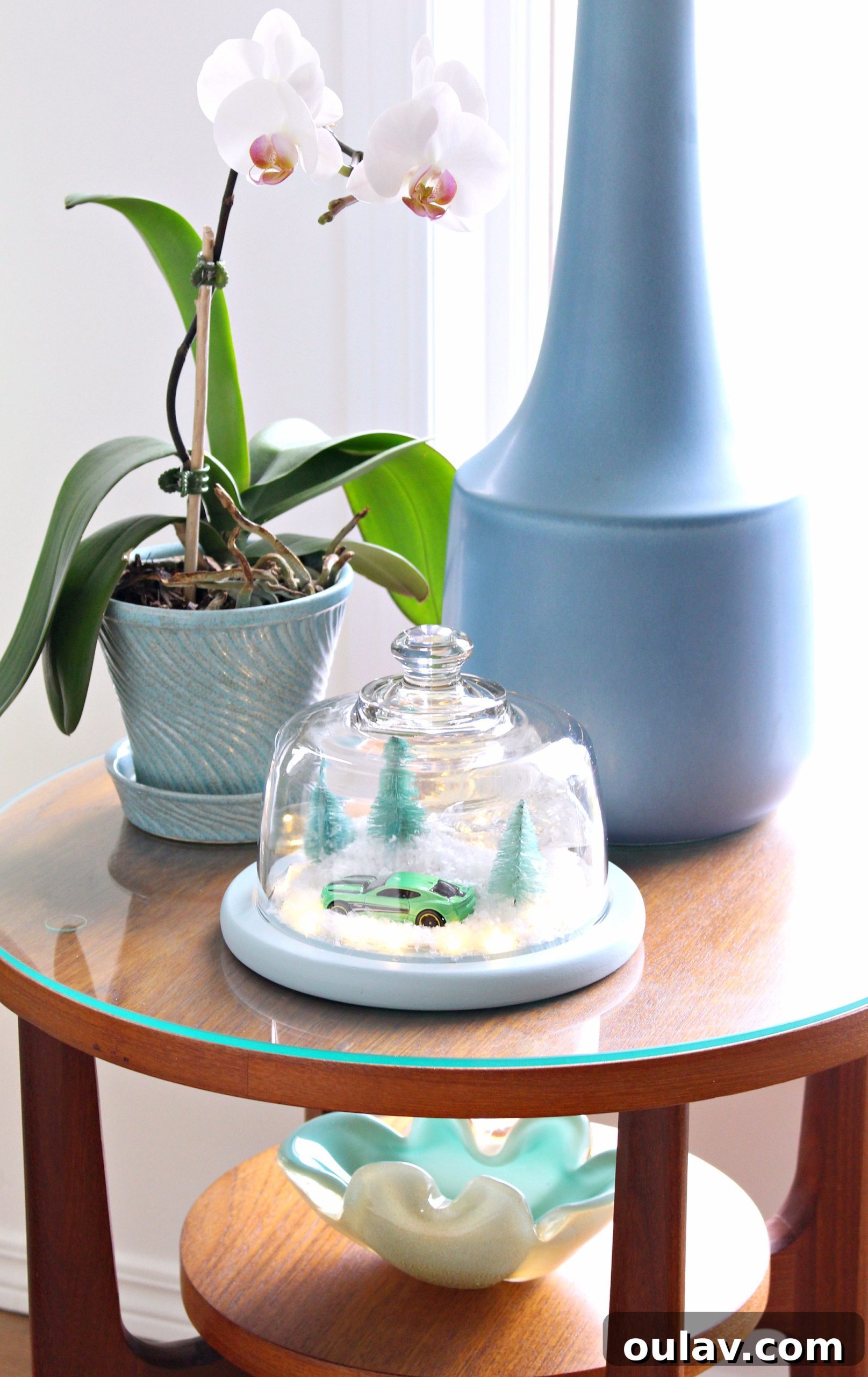 Gearhead's Festive Display Dome 8 Elegant DIY winter decor: a Camaro-themed cloche with soft lighting and artificial snow, perfect for modern holiday styling.