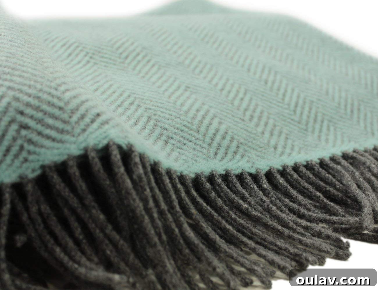 Holiday Haven: 25 Delightful Gifts for Homebodies 16 A John Hanley herringbone wool blanket in pale aqua and charcoal grey, draped invitingly.