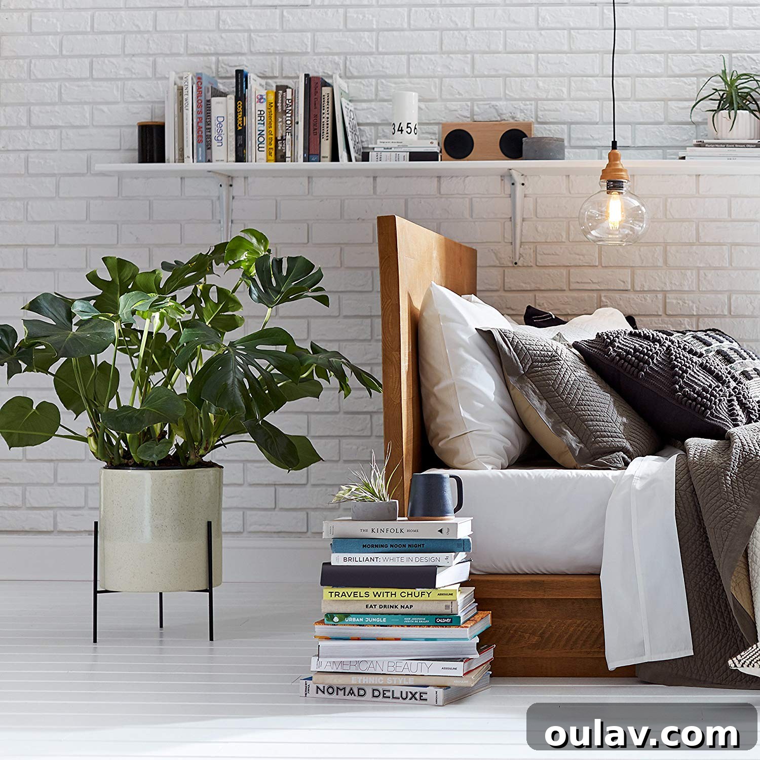 Holiday Haven: 25 Delightful Gifts for Homebodies 18 A stylish mid-century modern planter with a green plant, adding life to a minimalist interior.