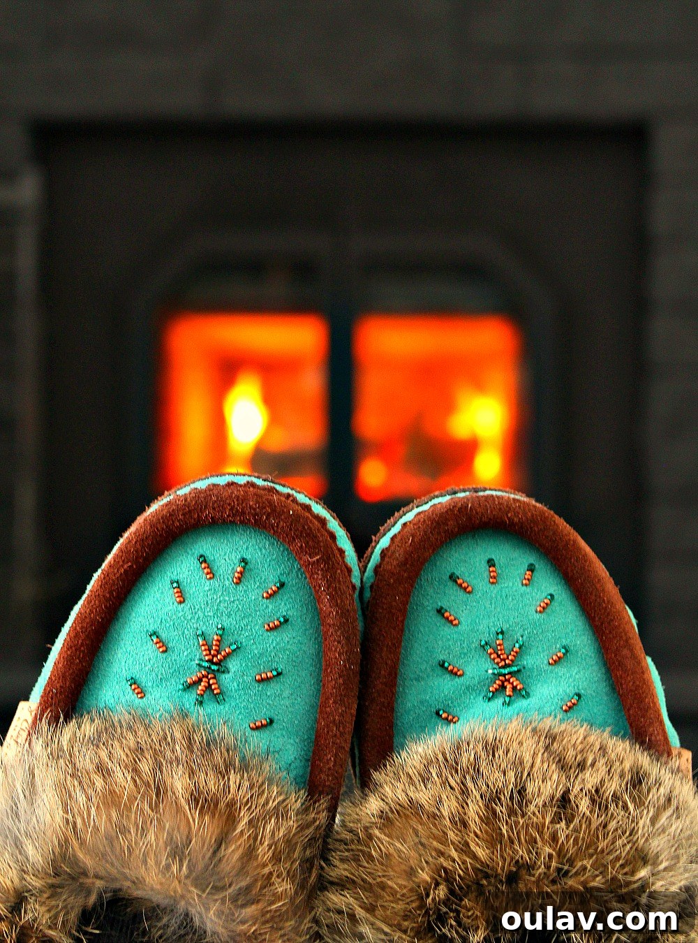 Holiday Haven: 25 Delightful Gifts for Homebodies 27 A pair of stylish beaded moccasin slippers on a wooden floor, perfect for home comfort.