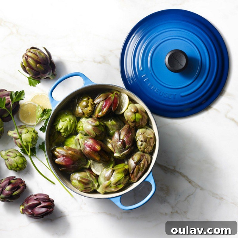 Holiday Haven: 25 Delightful Gifts for Homebodies 6 A close-up of Le Creuset cookware in a vibrant Caribbean blue, showcasing its quality enamel finish.