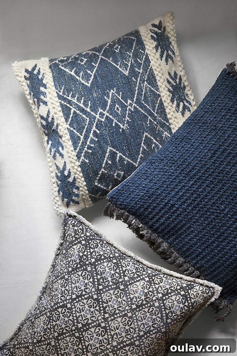 Holiday Haven: 25 Delightful Gifts for Homebodies 8 A close-up of a textured, light blue boho throw pillow, adding comfort to a home interior.