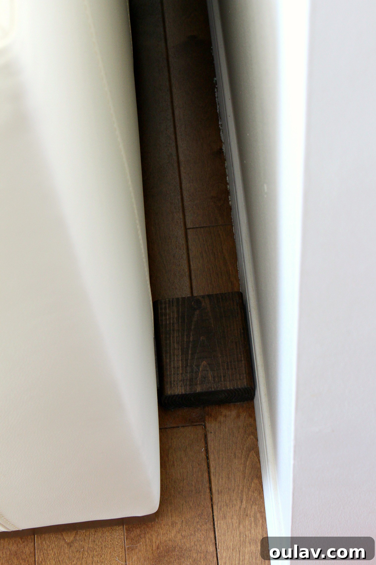 Side view of the sofa and art, revealing the subtle spacer creating a safe distance and preventing damage.