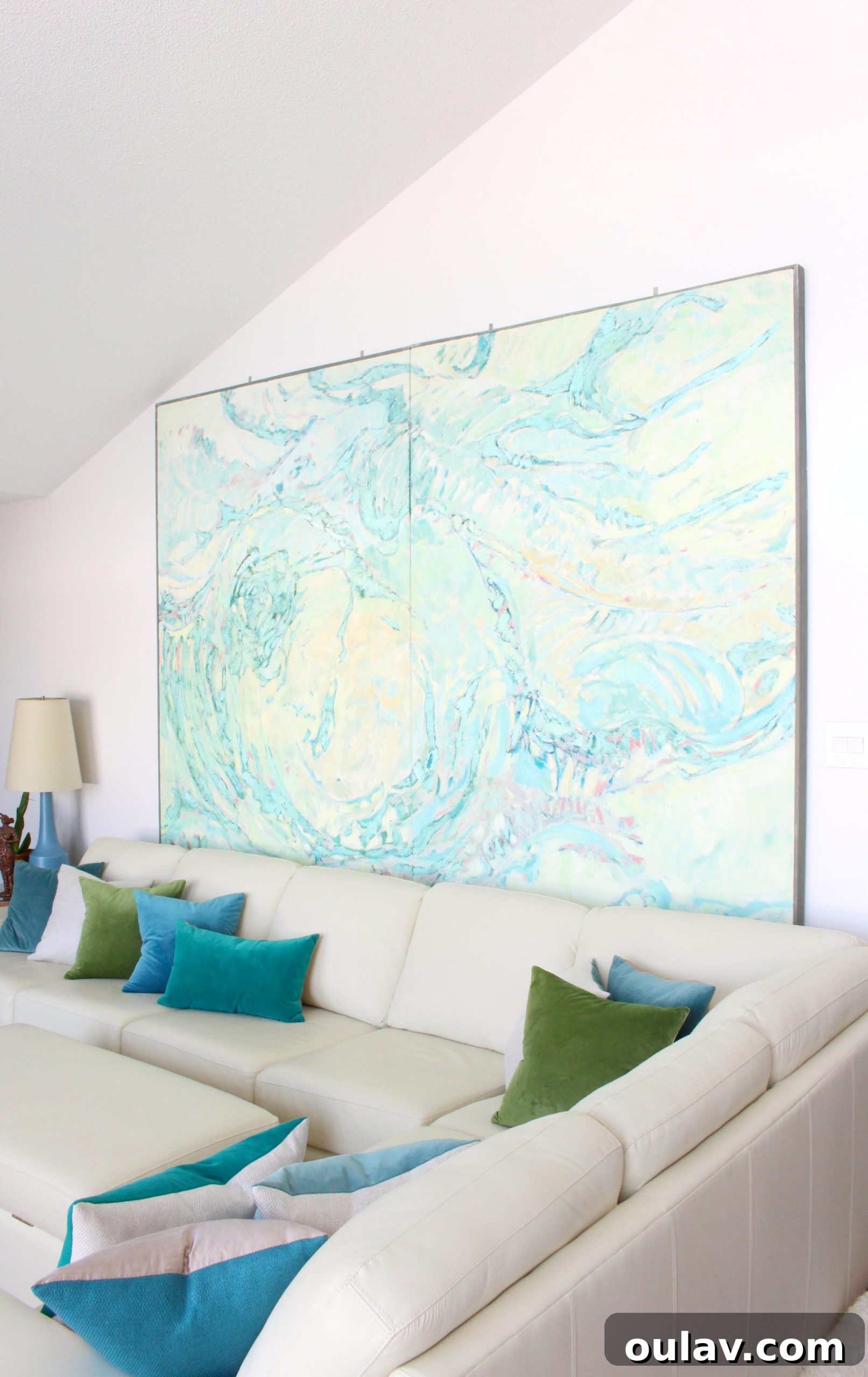 A beautifully composed living room showcasing the large painting and sofa, embodying perfect art and furniture arrangement.