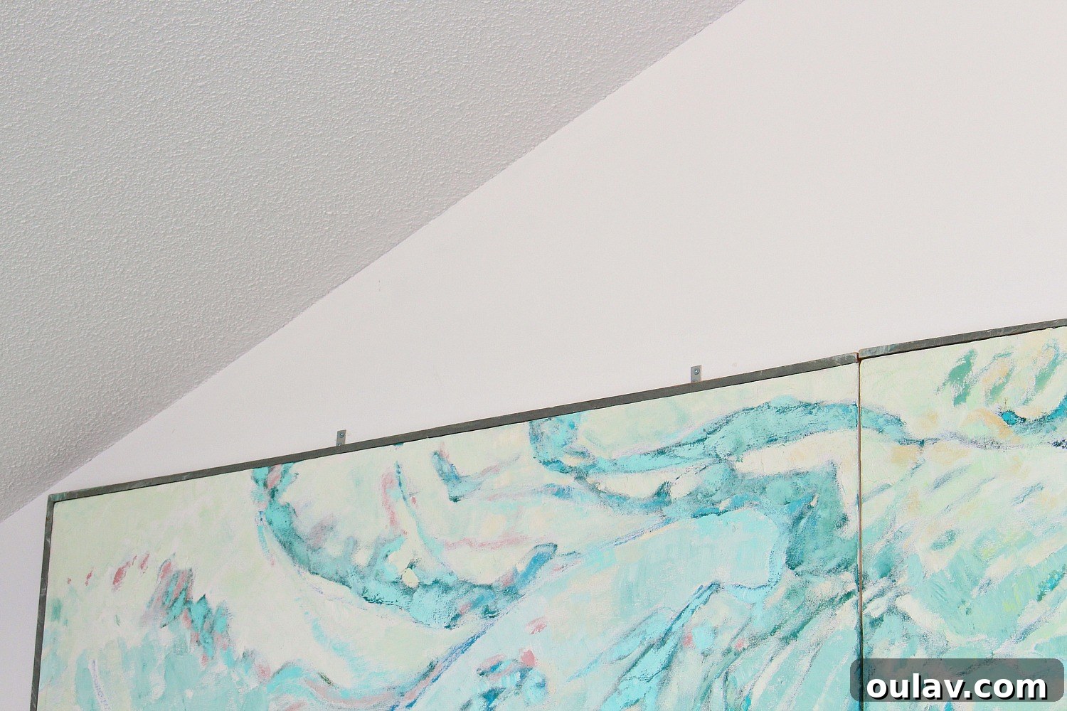 The securely hung large painting, showcasing the success of the corner brace method for heavy artwork.