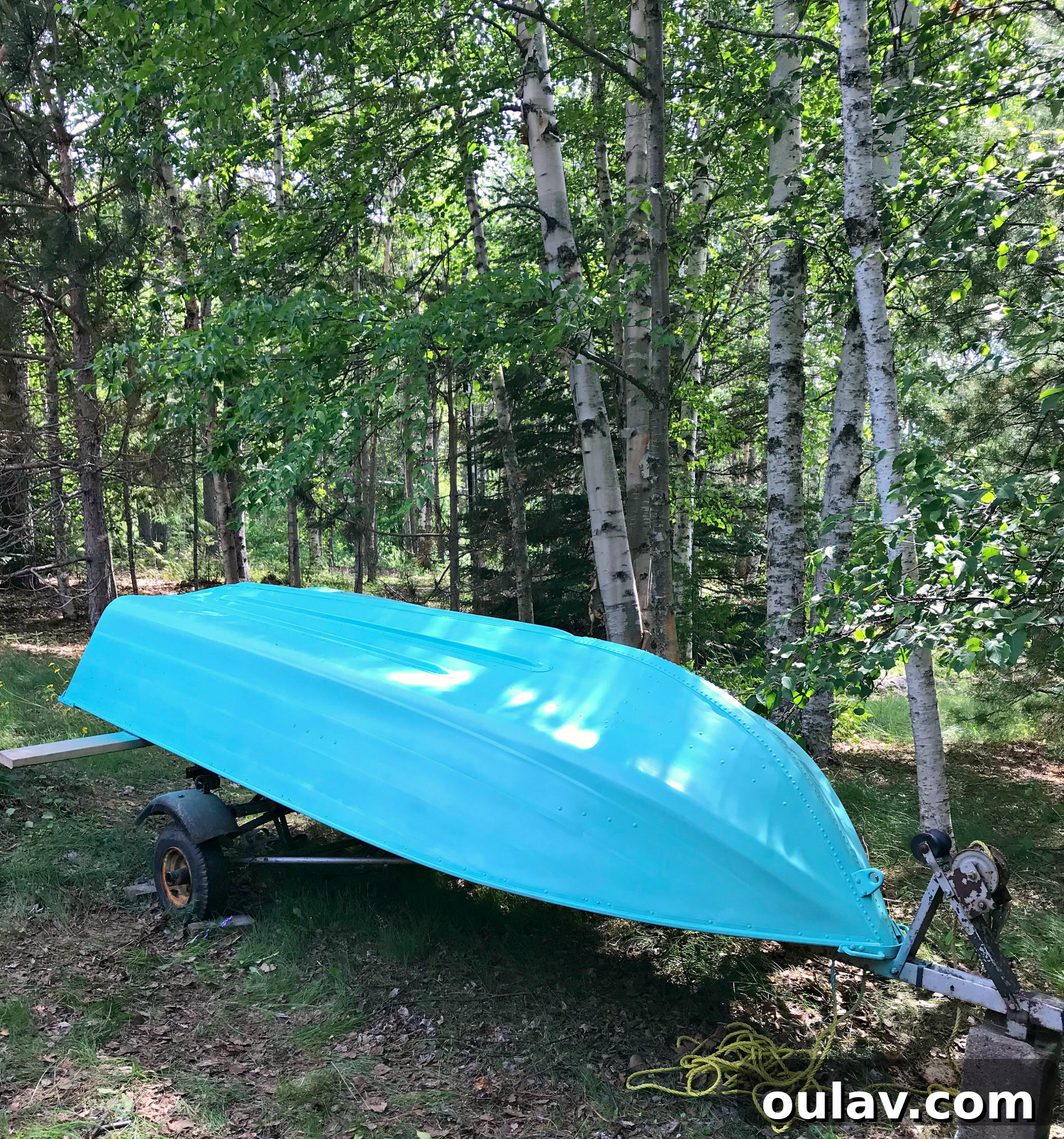 Detail shot of the smooth, vibrant turquoise lacquer applied to the aluminum boat.