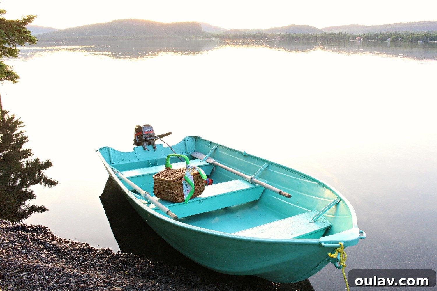 The newly painted turquoise boat gracefully moving through the waters of Lake Superior.