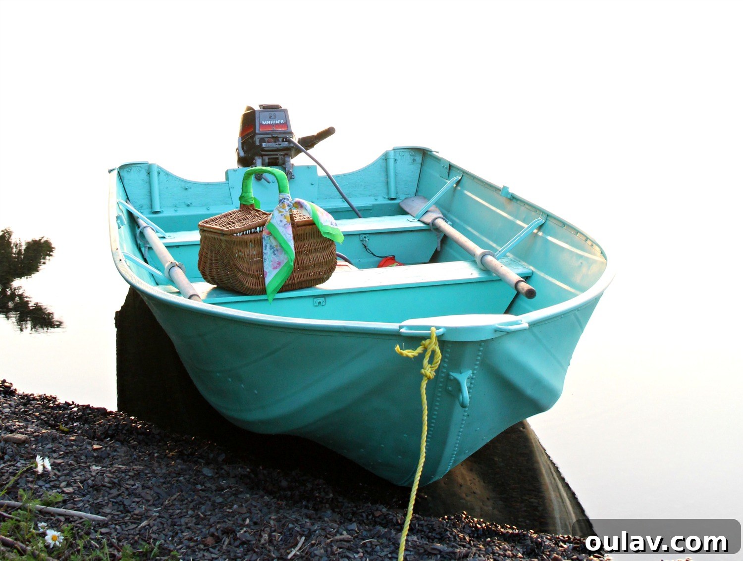 The vibrant turquoise aluminum boat sitting proudly on its trailer after the complete makeover.