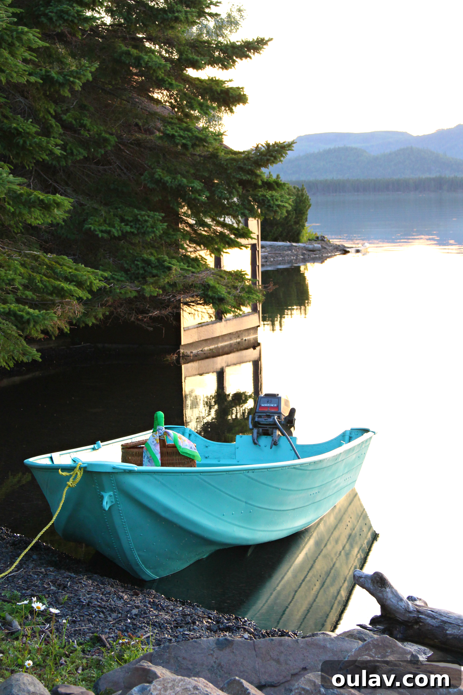 The aluminum boat gleaming in its new turquoise paint, showcasing the completed makeover.