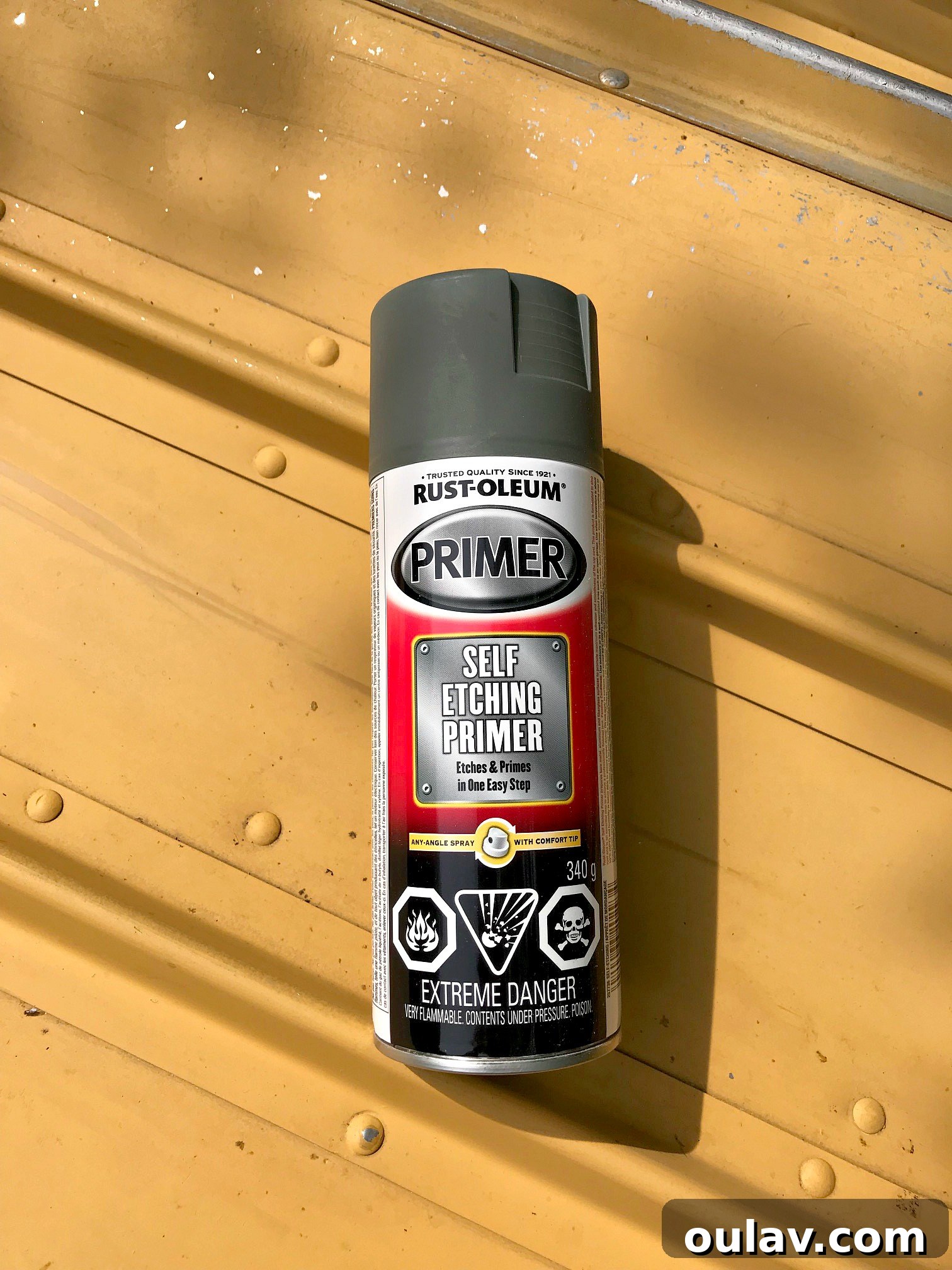 Pressure washing the exterior of the aluminum boat to ensure a pristine surface for painting.