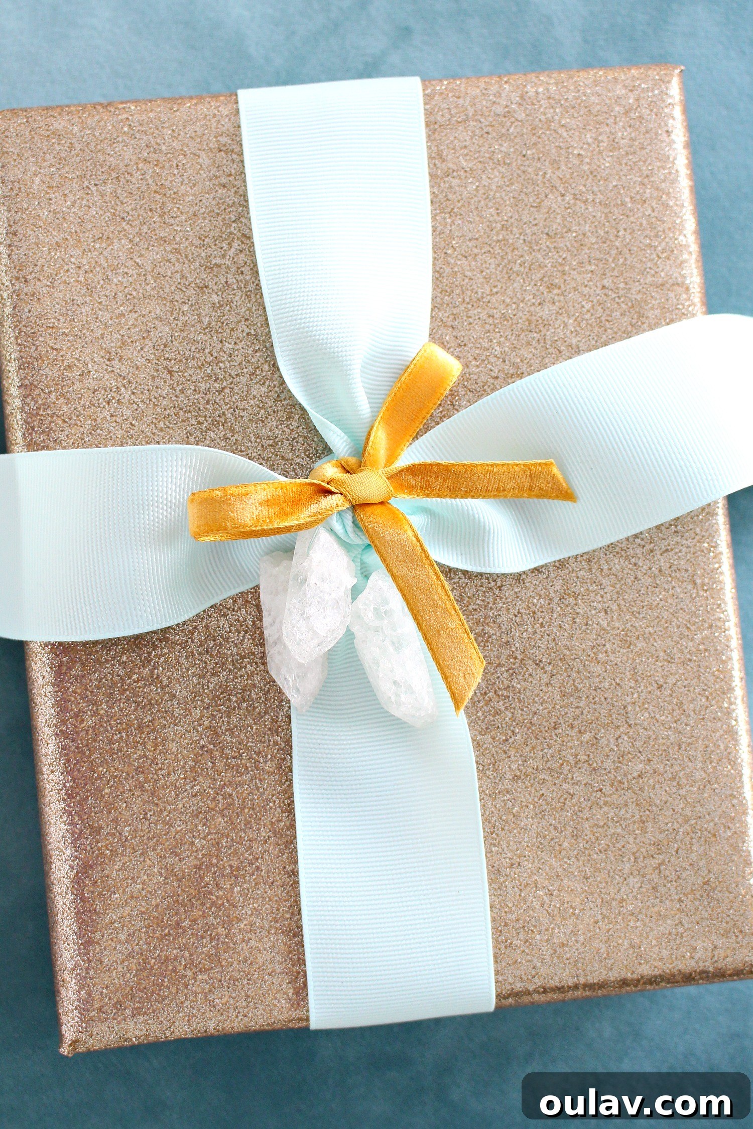 Crystal Point Glamour Gift Wrap 5 Detail shot of a crystal point tied onto a gift with pale aqua ribbon