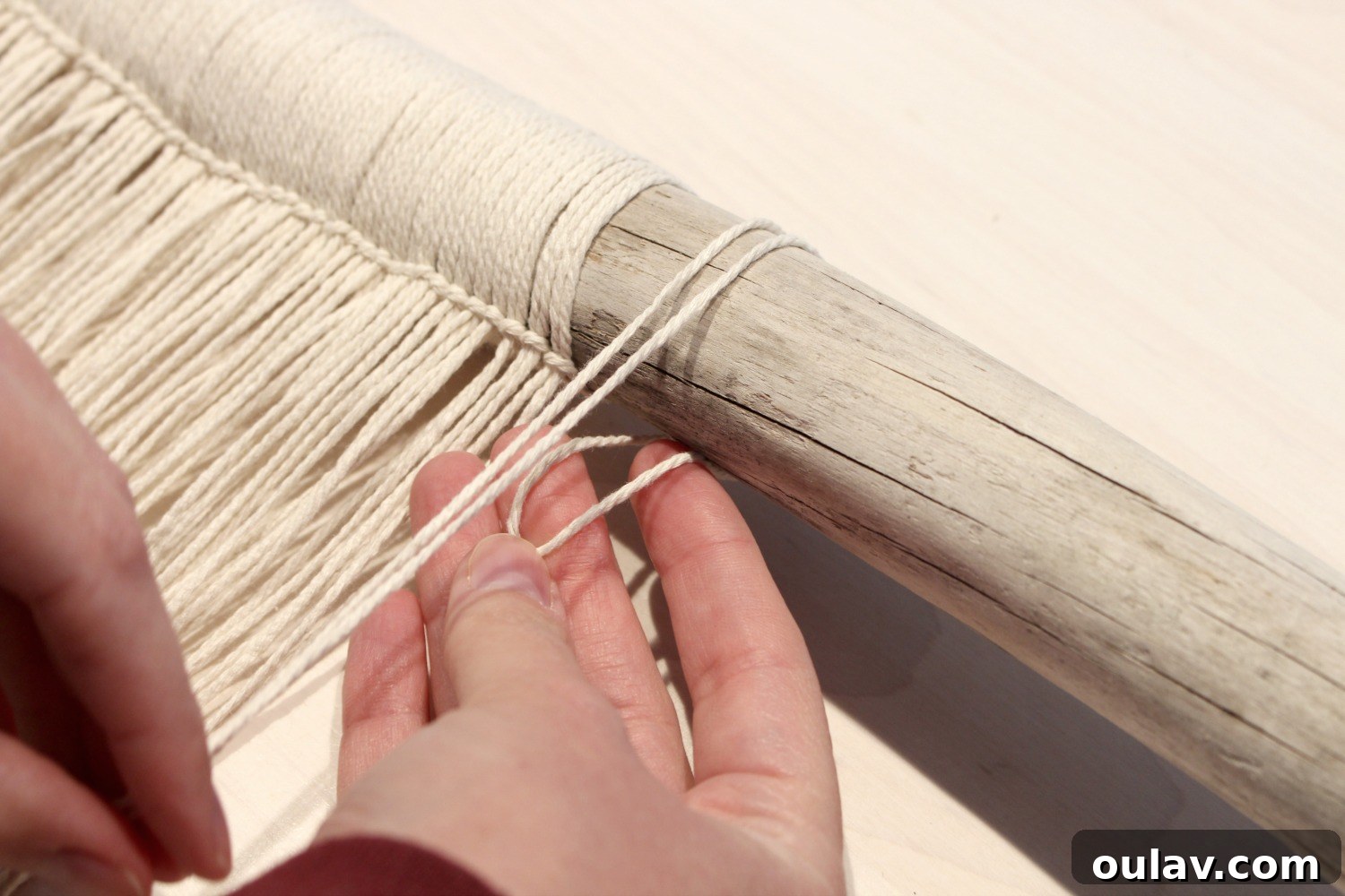 Handcraft Your Own Macrame Driftwood Wall Art 12 Step-by-step photos showing how to loop the cotton string onto the driftwood using a Lark's Head knot.