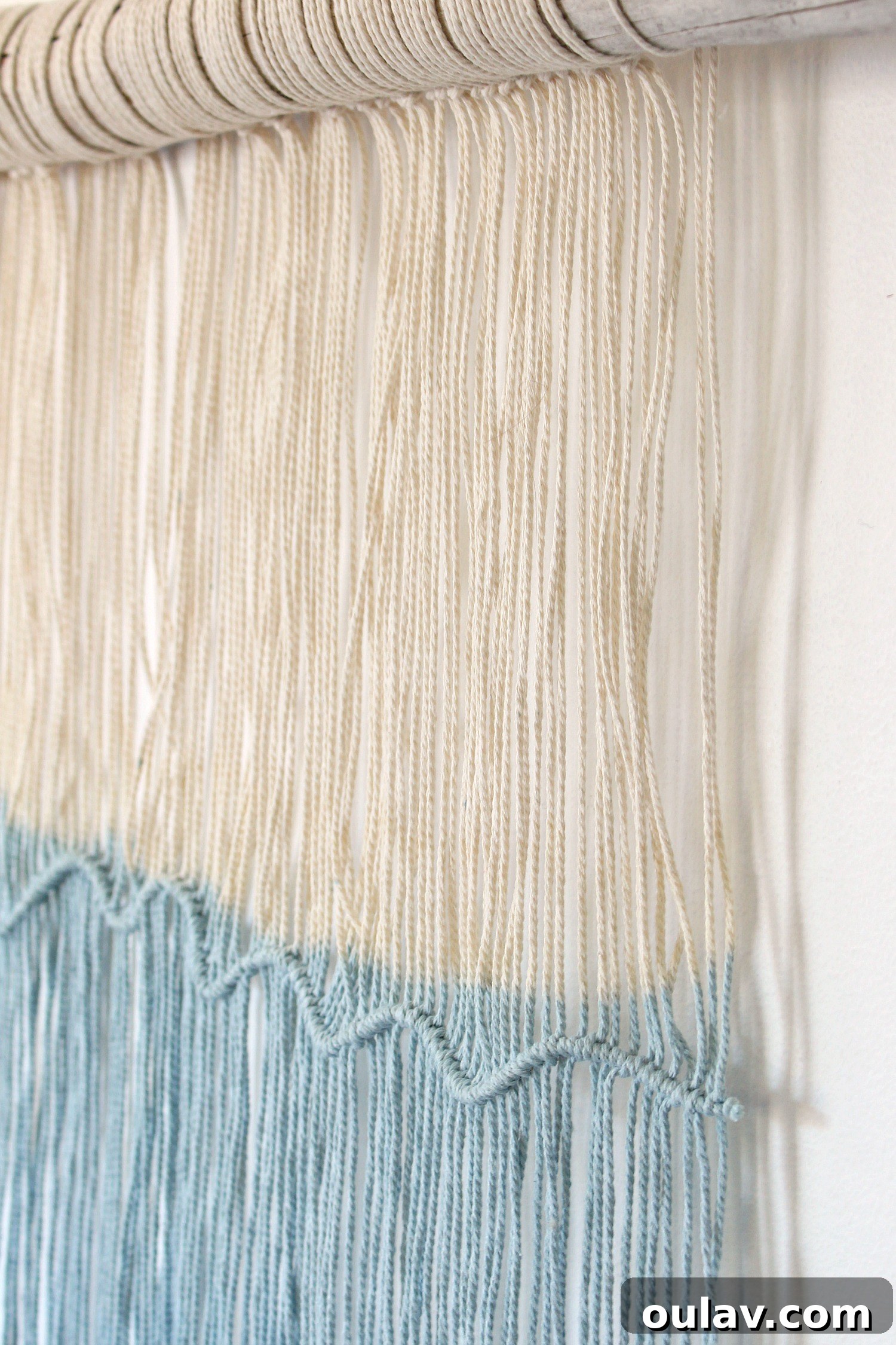Handcraft Your Own Macrame Driftwood Wall Art 3 A wider shot of the macrame and driftwood wall hanging, showing its full length and dip-dyed ends.