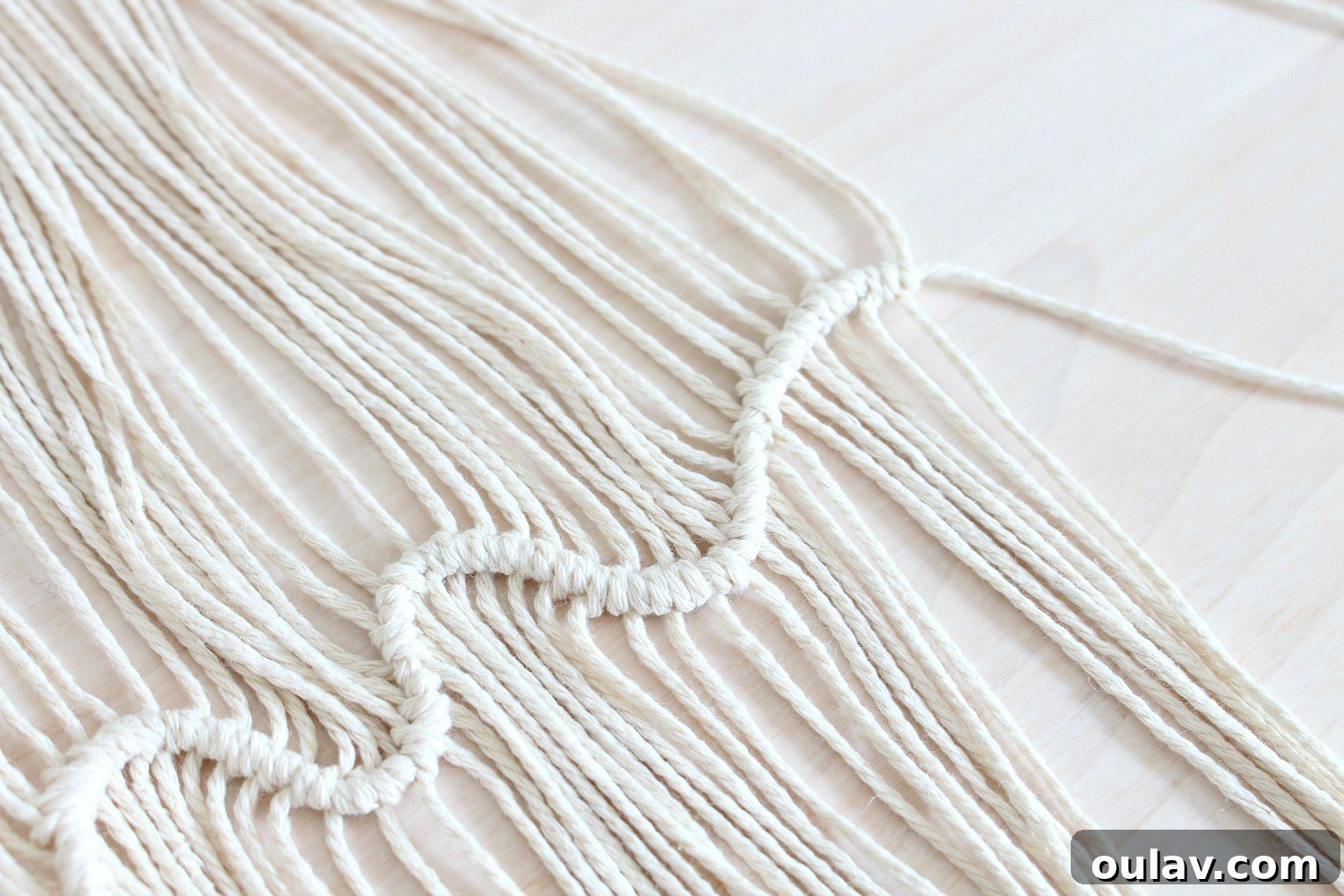 Handcraft Your Own Macrame Driftwood Wall Art 22 Photos illustrating how to manipulate the horizontal string's position to create the desired wave pattern with the knots.
