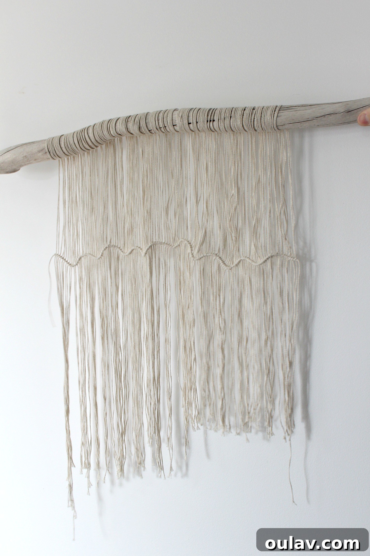 Handcraft Your Own Macrame Driftwood Wall Art 24 The final step of securing the horizontal string and trimming it after all knots are made.