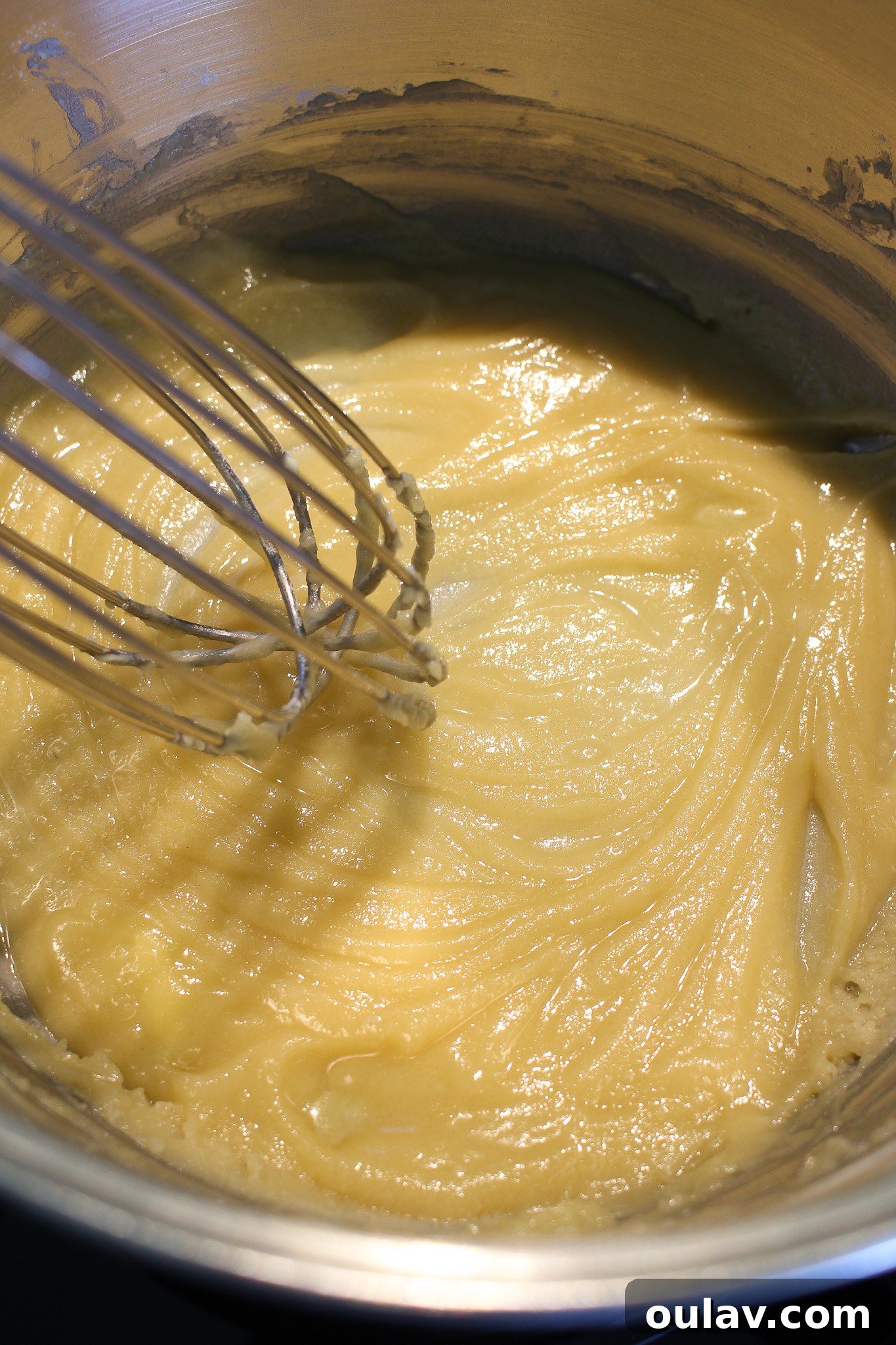 Whisking flour and butter into a paste for cheese sauce