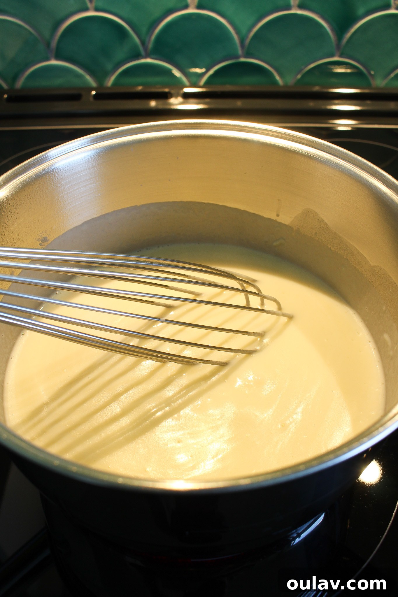 Thickening milk for mac and cheese sauce with a whisk