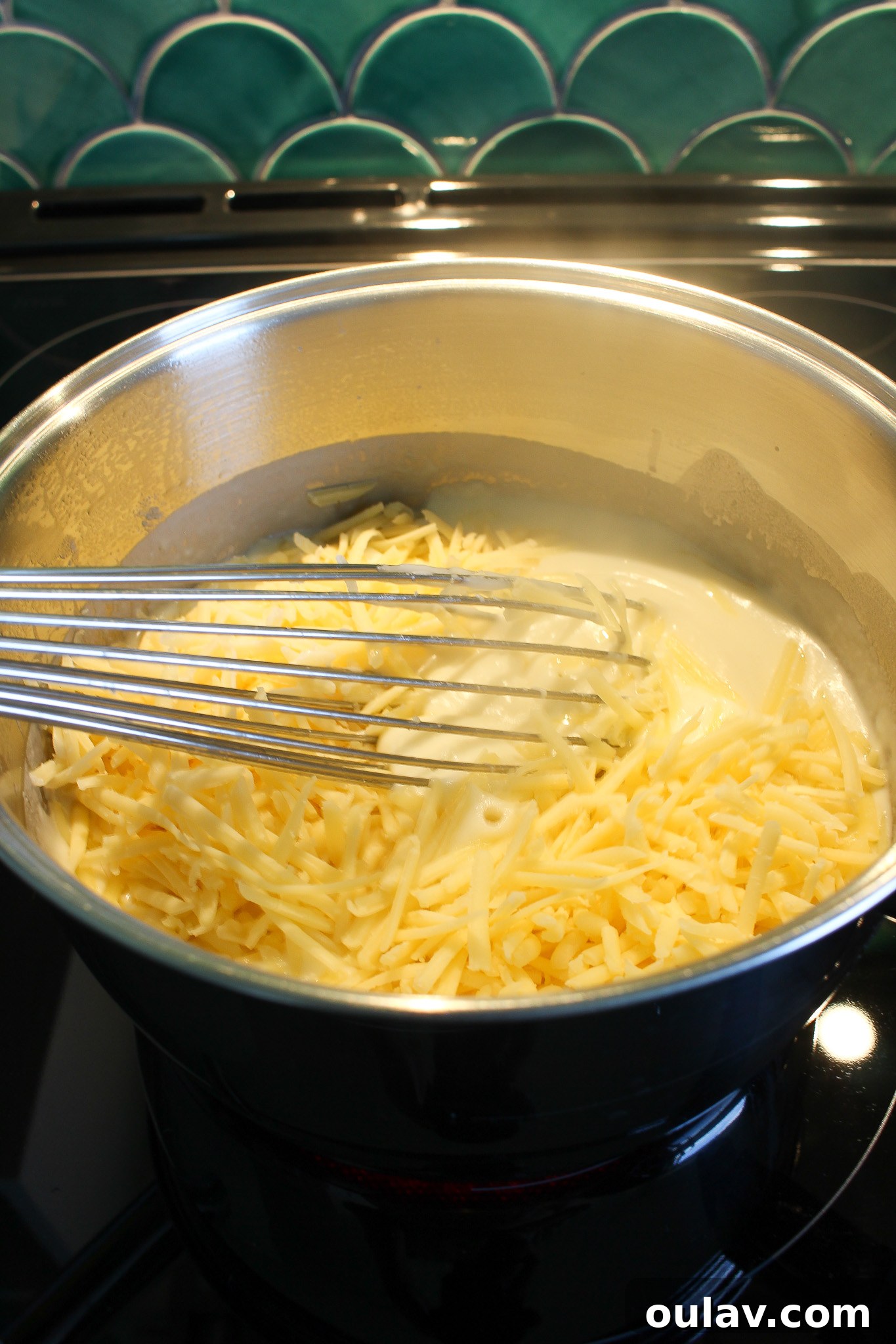 Adding spices and cheese to mac and cheese sauce